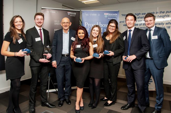 WInners of the Greggs Challenge 2016, dressed in smart suits, posing with their trophies